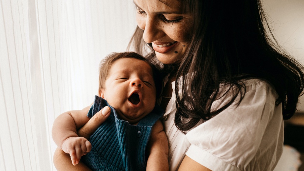 woman holding her newborn baby
