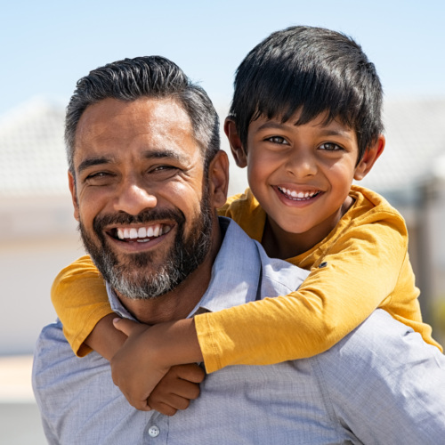 Father and son smiling together