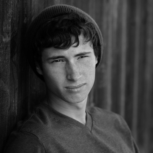 Male Youth in black and white looking past the camera.