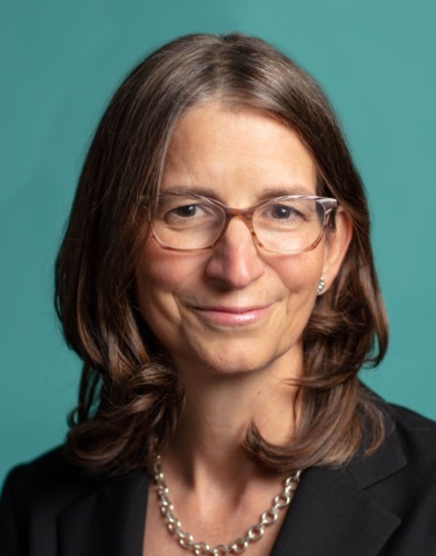 A woman wearing glasses and a black jacket.