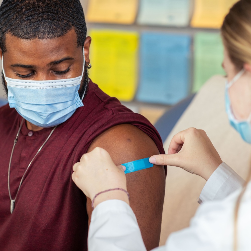 A man receives a bandage after a COVID-19 vaccination