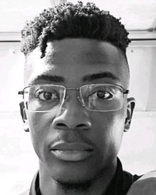 A black and white photo of a man with glasses.