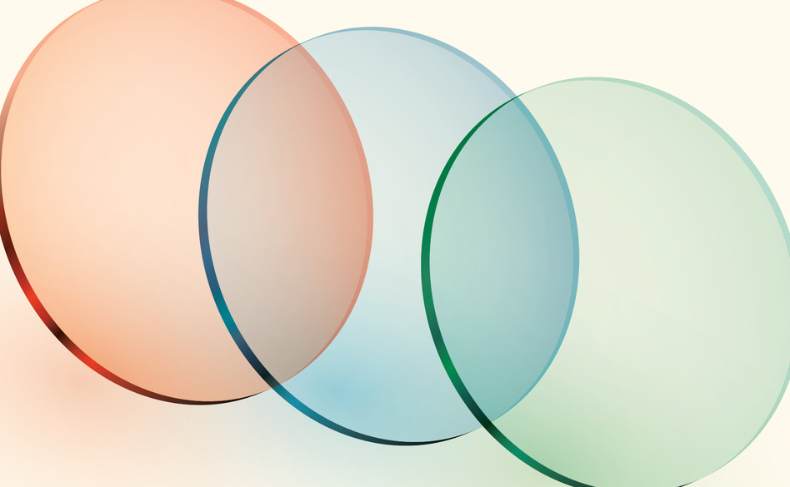 Three translucent overlapping circles in red, blue, and green are displayed on a pale background, creating blended color areas where they intersect.
