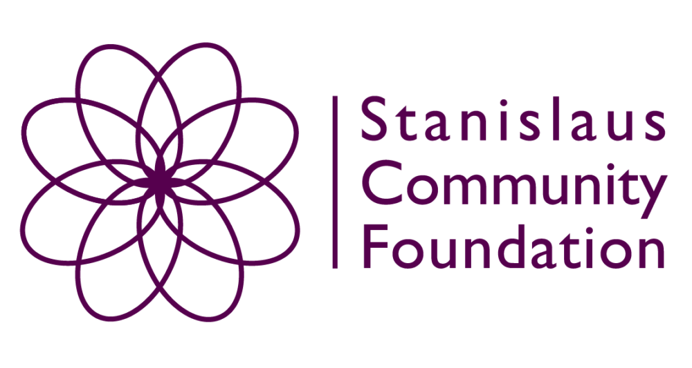 Stanislaus Community Foundation logo with a geometric flower design on the left and the organization name in purple text on the right.